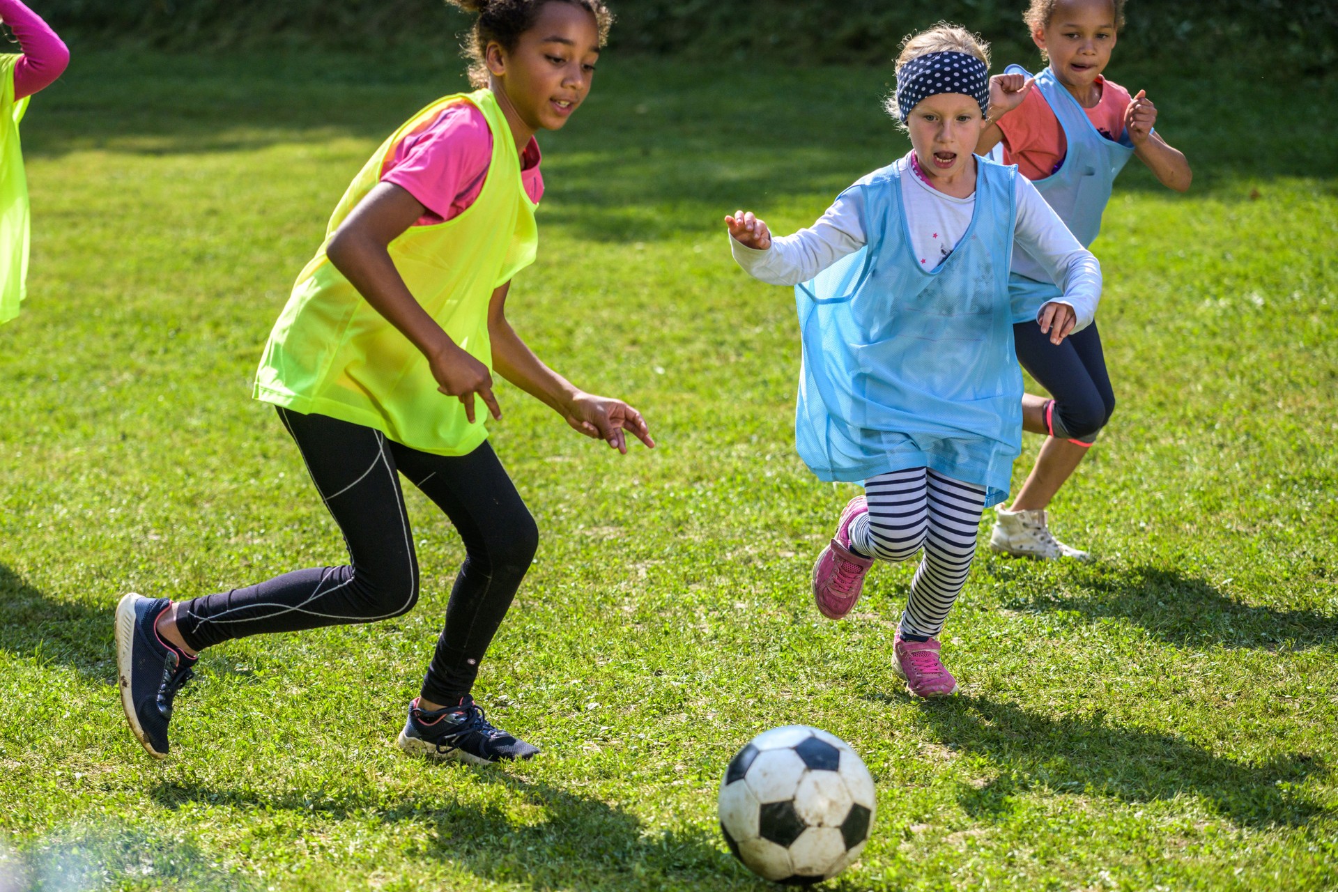 Girls playing match on soccer field